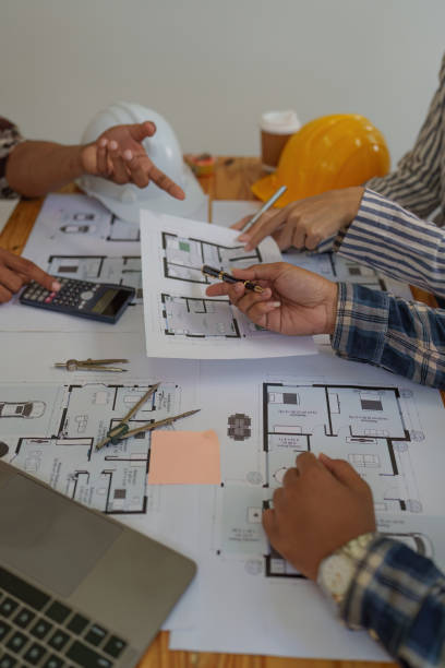 Professional architect designer structural engineer team colleagues discussing building plan design project Professional architect designer structural engineer team colleagues discussing building plan design project. office buddies stock pictures, royalty-free photos & images