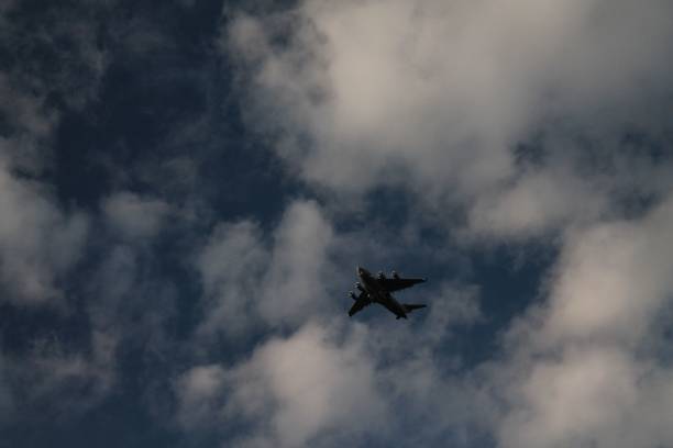 istock aircraft in the cloudy sky 1444080243