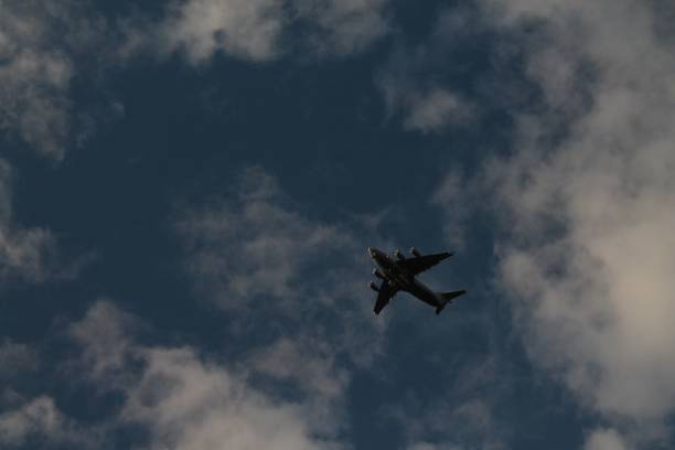 istock aircraft in the cloudy sky 1444080245