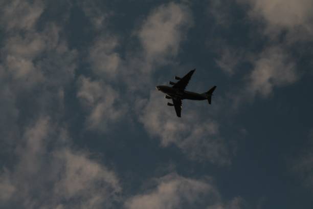 istock aircraft in the cloudy sky 1444080247