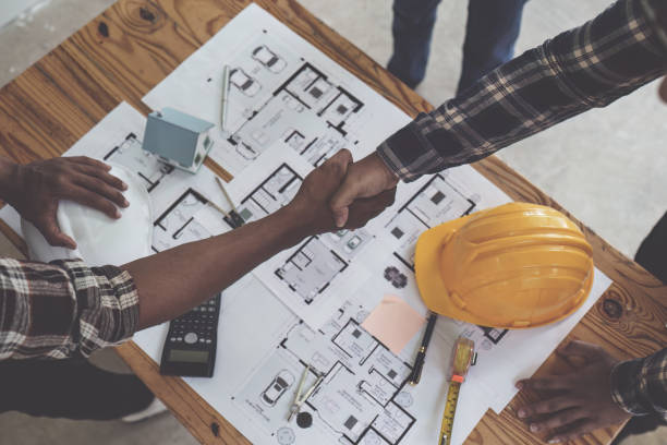 istock Architect and engineer construction workers shaking hands after finish an agreement in the office construction site, success collaboration concept 1444080458
