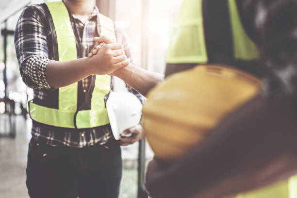 istock Architect and engineer construction workers shaking hands after finish an agreement in the office construction site, success collaboration concept 1444080499