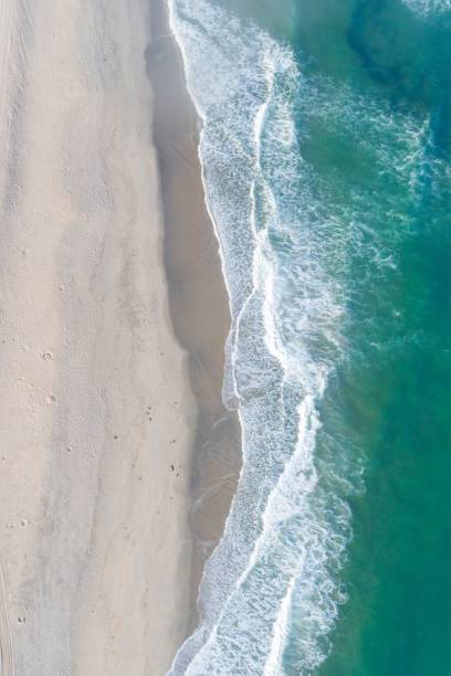 istock Beautiful white empty beach and sea waves seen from above. 1444083070