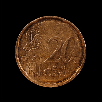 A twenty euro cent coin isolated on a black background