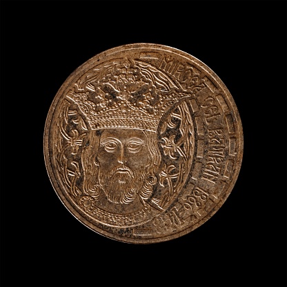 An antique coin over a black background