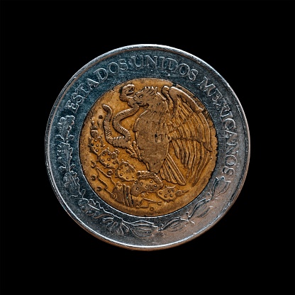 An old coin isolated on a black background