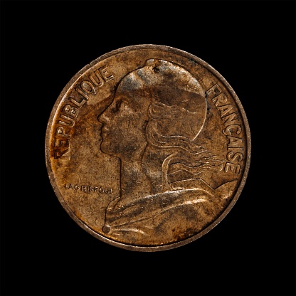 An old coin isolated on a black background