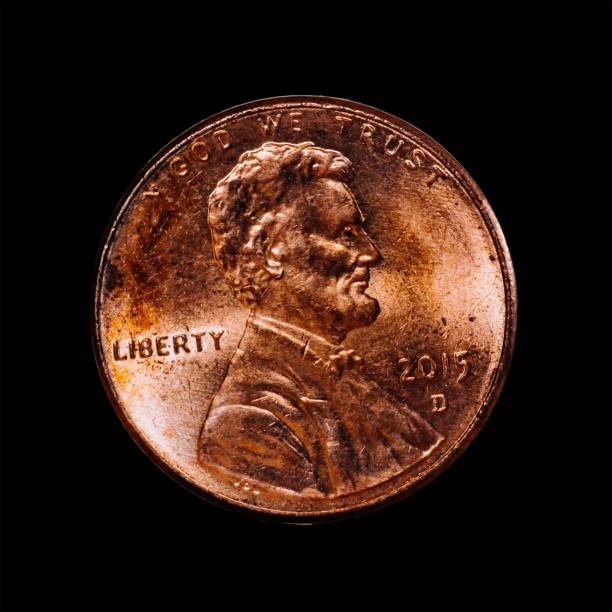 istock Closeup of a 1 US dollar cent from 2015 also called penny isolated on a black background 1444085240