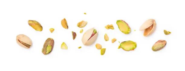 Pistachio nuts with shell and chopped pistachios isolated on white background