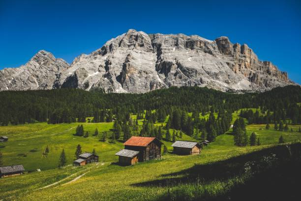 istock Mesmerizing scenery of the Dolomites overlooking meadows with huts 1444086703