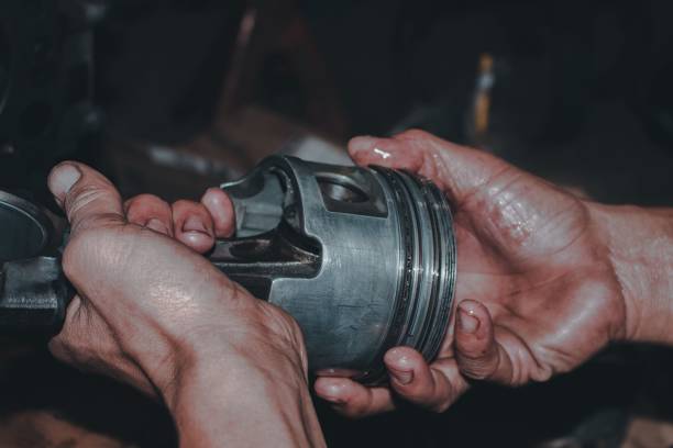 istock Closeup shot of mechanic hands checking an engine to fix 1444088259