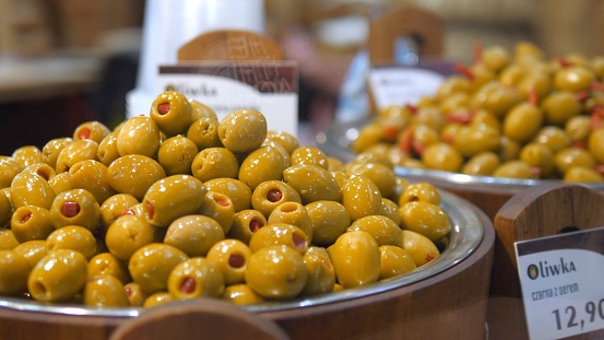 Close up of olives stuffed with pimentos demonstrated in local food marked. Stuffed olives in a natural sauce for long-term storage are displayed in the self-service supermarket.
