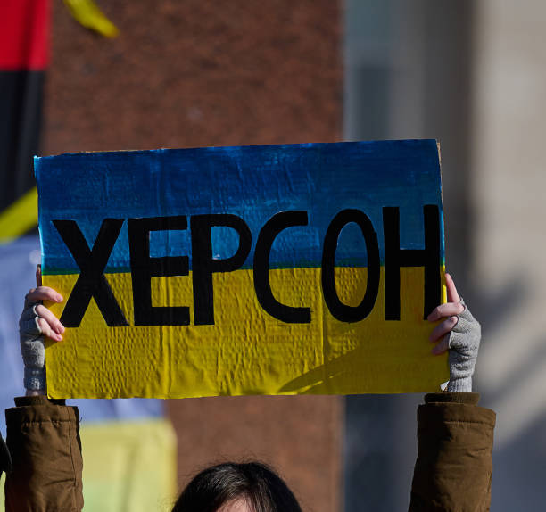 istock Women's hands hold a poster with the inscription Kherson 1444090824