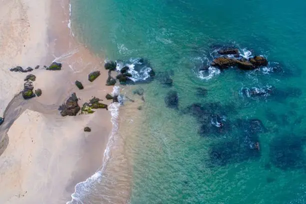 Photo of aerial view of a empty beach in the northern part of Portugal with turquoise waters.
