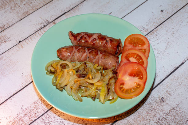 istock Sausage baked in a pan with onions. 1444094327