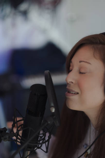 Singer/songwriter Criibaby in the studio, performing their new music. Their lyrics are not gender specific, and are informed by their lived experience as femme and nonbinary.