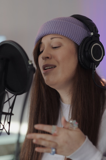 Singer/songwriter Criibaby in the studio, performing their new music. Their lyrics are not gender specific, and are informed by their lived experience as femme and nonbinary.