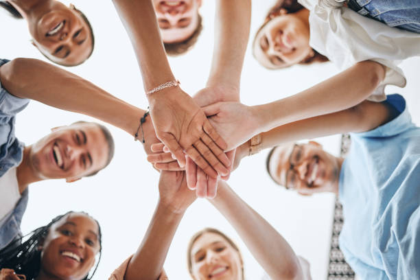 istock Team, vision and hands in support of team building activity with diverse colleagues having fun outdoors. Goal, mission and collaboration with happy employee group join hand for motivation and target 1444099390