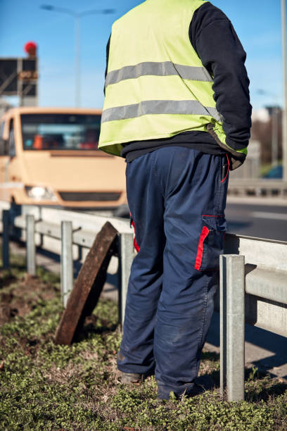 istock Construction maintenance workers working at public site street road. 1444100332