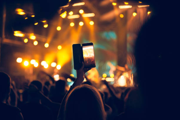 istock Person holding modern smartphone on a concert. 1444100728
