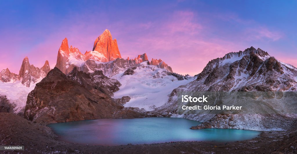 Fitzroy's red burning peak and Laguna-De-los-Tres at sunrise, Patagonia, Argentina. South America Patagonia - Argentina Stock Photo