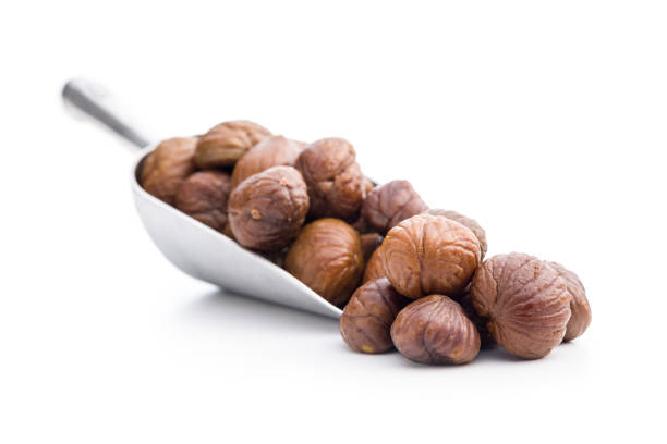 Peeled chestnuts. Sweet roasted chestnuts in scoop isolated on the white background.