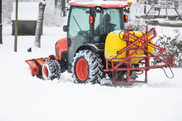 istock Tractor cleaning urban park paths on a cold snowy day. 1444101611