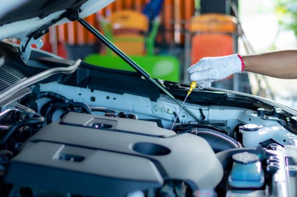 istock Engineer checking oil level in car service centre 1444102898