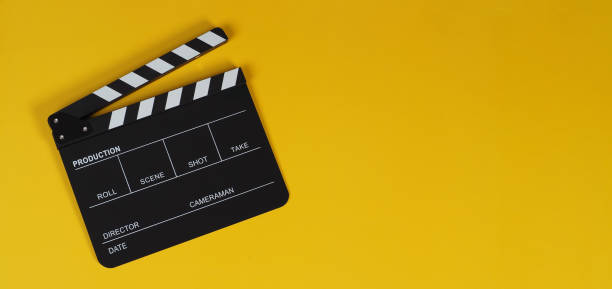 istock clapper board or movie slate on yellow background. 1444103816