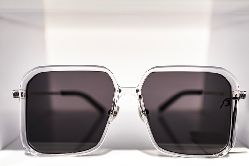 Black sunglasses or shades, with plastic rims and tinted lenses, both modern and retro fashion. Isolated on a white background with clipping path.