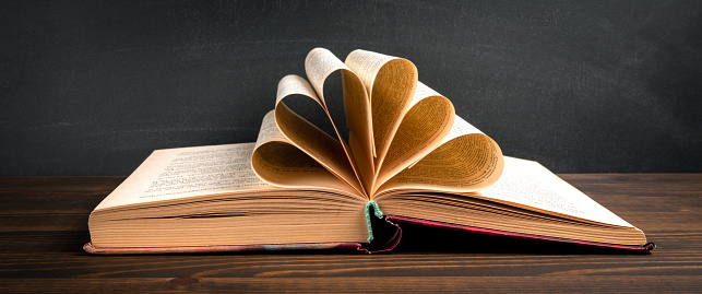 Old book on a wooden table. Learning and development concept.