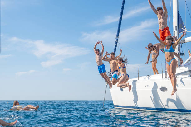 istock Friends jumping in sea 1444105516