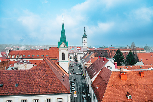 High angle view on street leading to St. Mark's church, towers and rooftops, Zagreb in winter