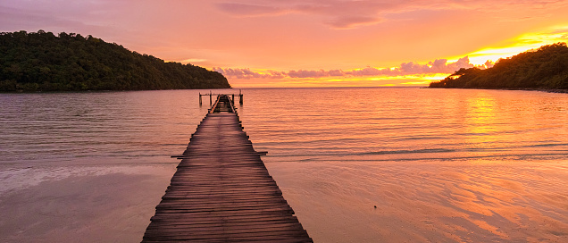 sunset on the tropical beach of Koh Kood Thailand. wooden pier during sunset