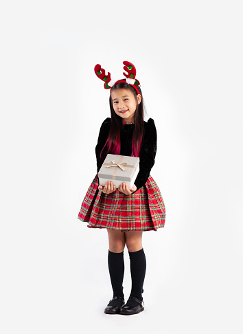 Asian girl in black sweater christmas theme costume holding present box full length white background.