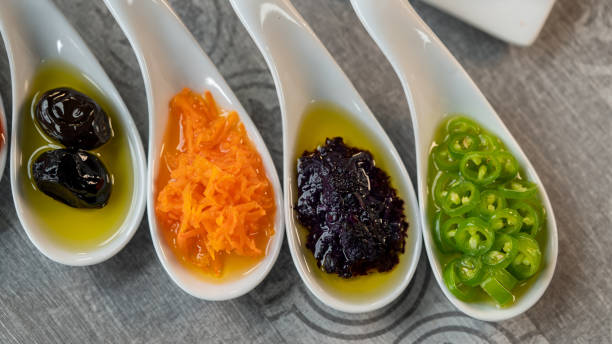 Green and black olives at breakfast on tabletop view.