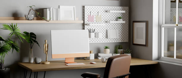 istock Modern home working room with computer and accessories on wood table against grey wall 1444114846