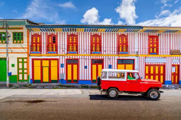 A car passing on the colourful street of Tolima Colombia the little town in a sunny day.