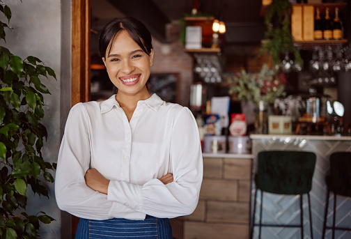 Small business success, cafe restaurant and happy woman leader portrait in Costa Rica hospitality industry. Confident coffee shop manager, waiter food service with apron and store entrance welcome