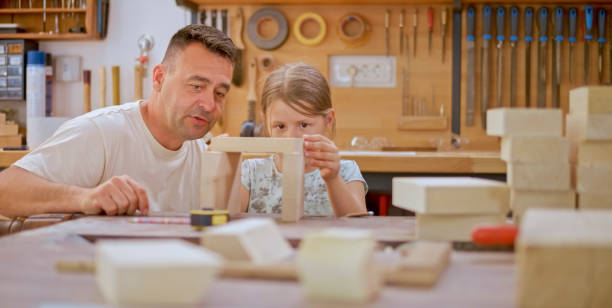 istock Father observing his daughter stacking blocks 1444119432