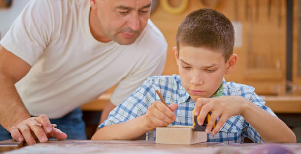 istock Father observing his son mark measurement 1444119439