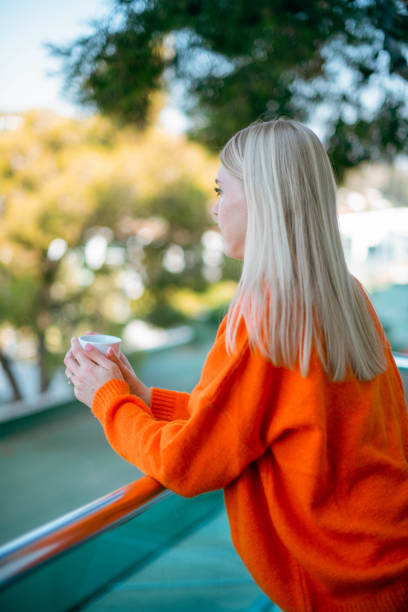 istock Meditative Woman is Drinking Coffee on the Balcony 1444119554
