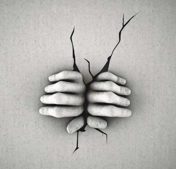 Two hands breaking a wall. Escape and freedom concept.