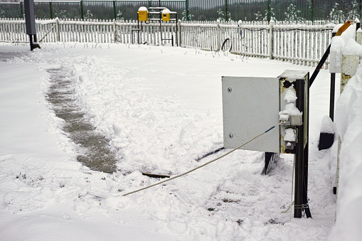 open fuse box and cable during fixing a problem, winter scene