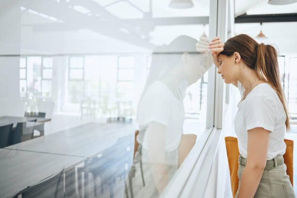 istock Burnout, frustrated and sad student by classroom window for fail, mistake or bad time management with mental health problem. Depressed, tired and fatigue college woman with study headache university 1444122799