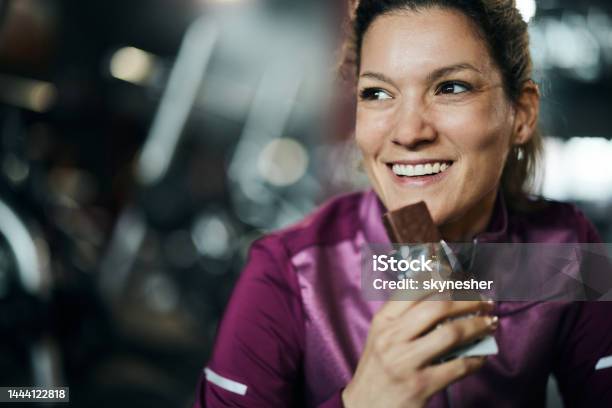 Eating Protein Bar On A Break Stock Photo - Download Image Now - Eating, Chocolate, One Woman Only