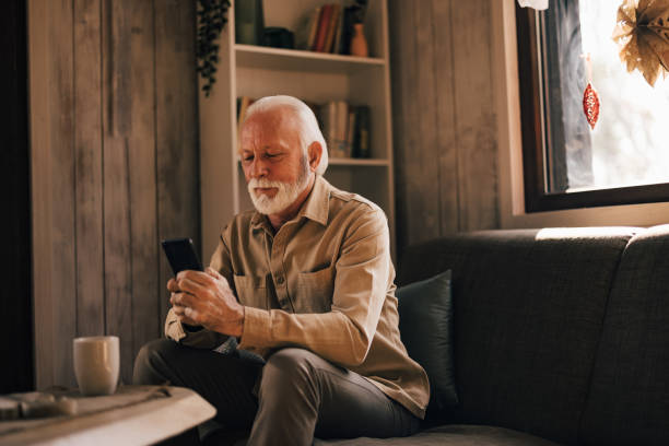 istock Focused mature male, using a mobile phone, spending time at home. 1444124596