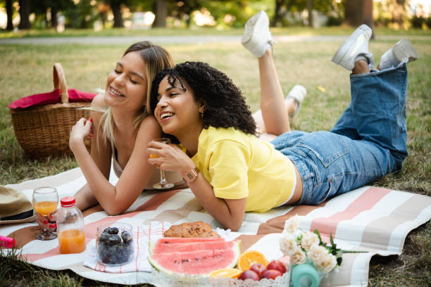 Portrait of two besties enjoying on a picnic and having fun stock photo