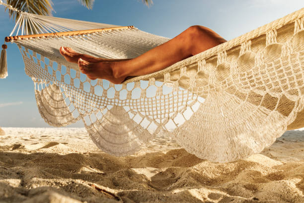 istock Unrecognizable woman's legs on a hammock at the beach. 1444126064