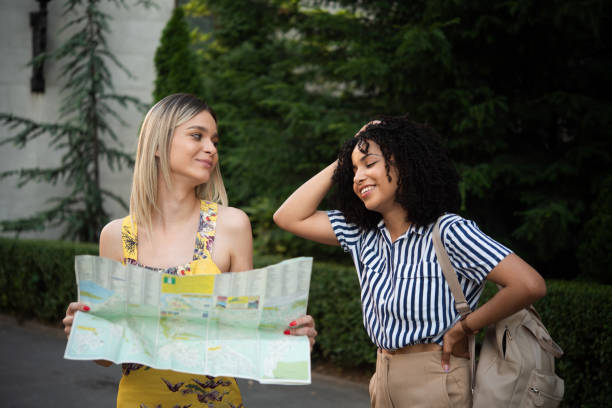 istock Two girls on a journey exploring the map and having fun 1444128561